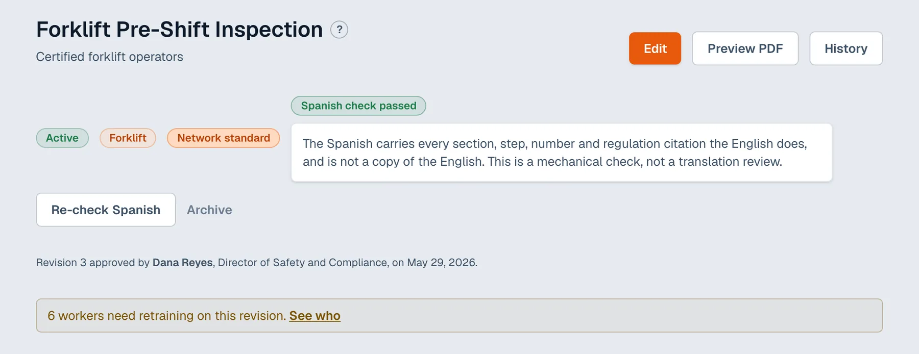 The Forklift Pre-Shift Inspection SOP in the app, with the Spanish check open, the revision 3 approval line, and a banner saying six workers need retraining on this revision.